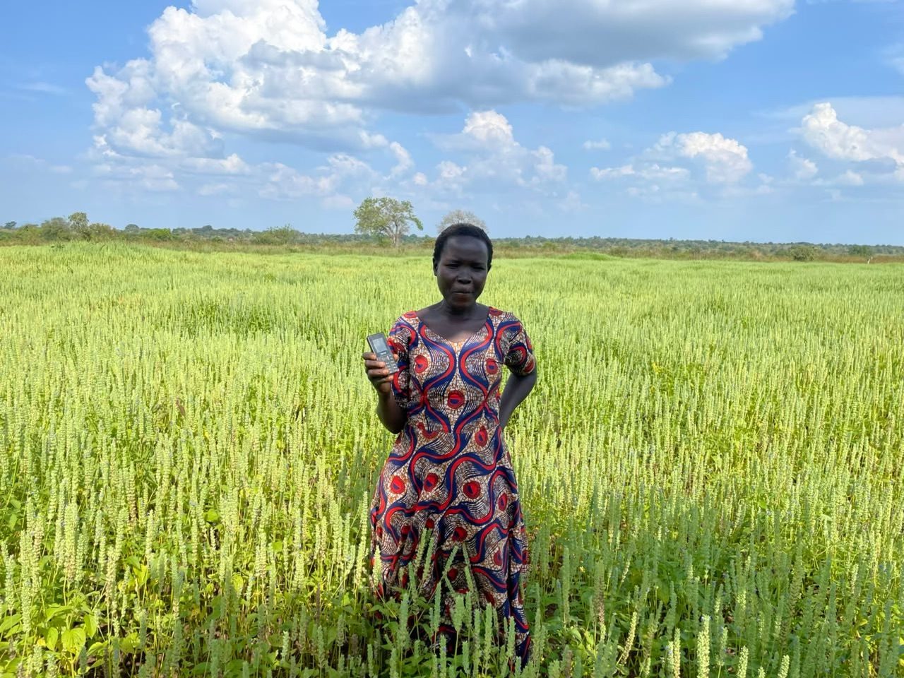 A smallholder farmer standing in her organic chia field in Uganda
