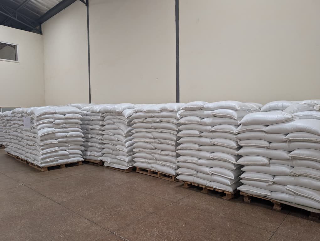 Pallets of bagged organic product stacked in a clean warehouse